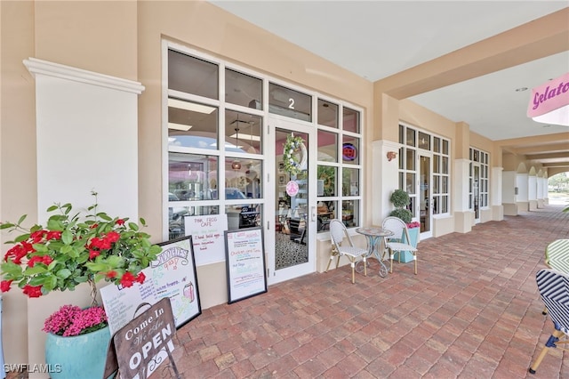 entrance to property featuring stucco siding