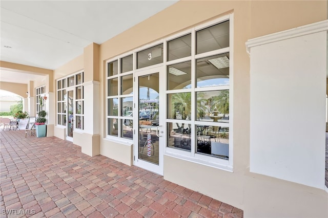 view of exterior entry featuring stucco siding