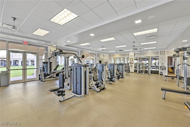 exercise room with french doors and a paneled ceiling