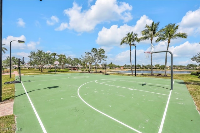 view of sport court featuring community basketball court and a water view