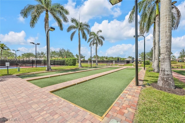 view of home's community featuring a bocce ball area and fence