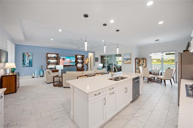 kitchen with recessed lighting, a sink, light countertops, decorative light fixtures, and marble finish floor