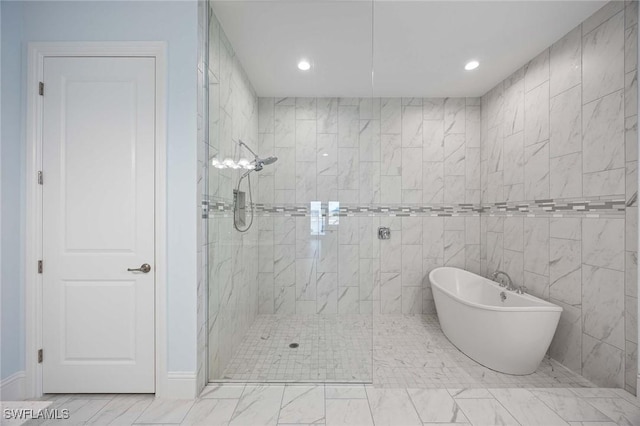 bathroom featuring recessed lighting, a freestanding bath, and walk in shower