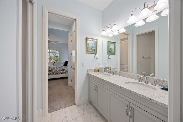 full bath with double vanity, marble finish floor, ensuite bathroom, and a sink