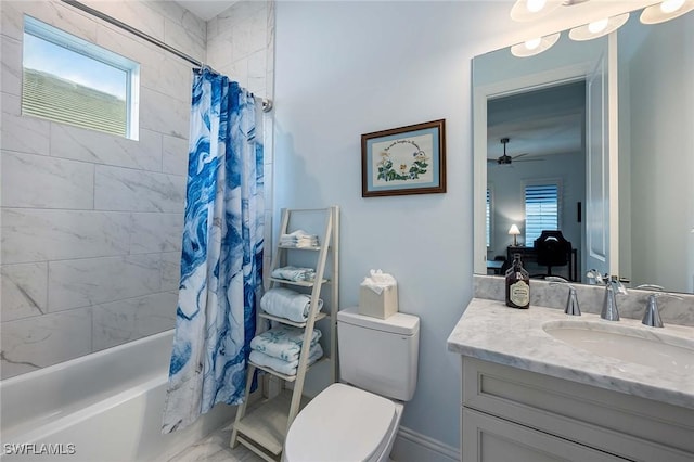 bathroom featuring toilet, vanity, ceiling fan, and shower / bath combo