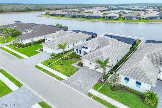 birds eye view of property with a residential view and a water view