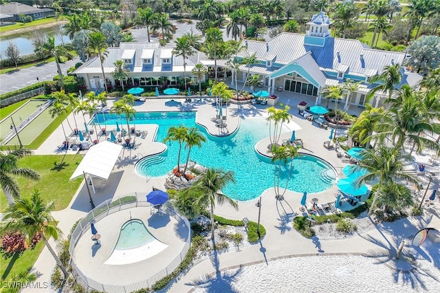 pool with a patio area and a water view