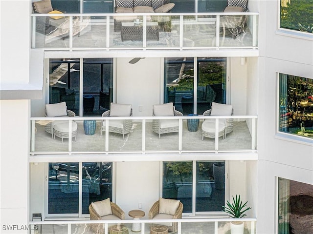 interior space with an outdoor living space and stucco siding