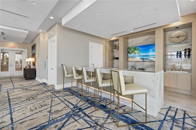 bar featuring baseboards, french doors, and recessed lighting