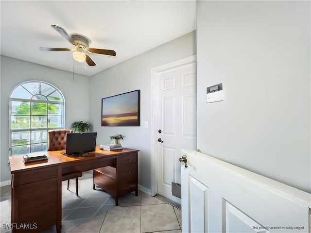 office area featuring ceiling fan, light tile patterned flooring, and baseboards