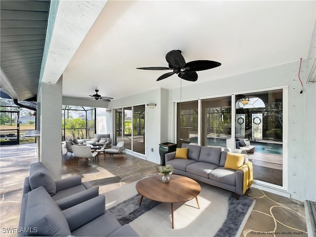 view of patio / terrace with a ceiling fan, glass enclosure, and an outdoor hangout area