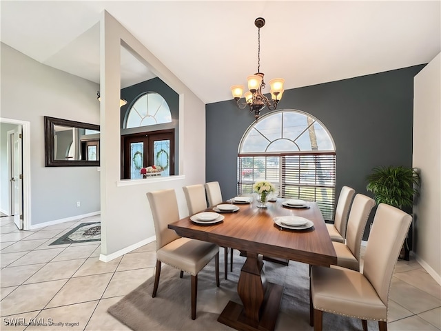 dining space featuring baseboards, an inviting chandelier, and light tile patterned floors