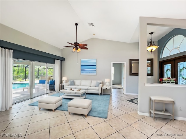 living area featuring a ceiling fan, visible vents, high vaulted ceiling, and light tile patterned floors