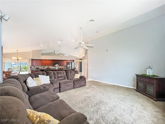 living area with light colored carpet, visible vents, high vaulted ceiling, baseboards, and ceiling fan with notable chandelier