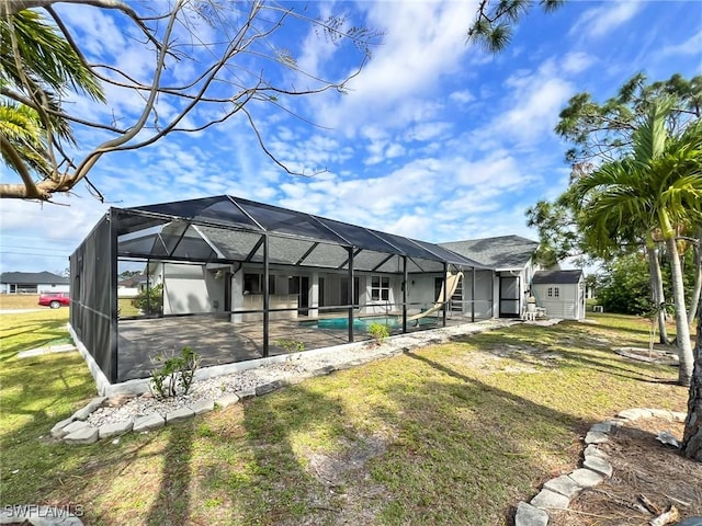 exterior space featuring glass enclosure, an outdoor pool, a lawn, and a patio