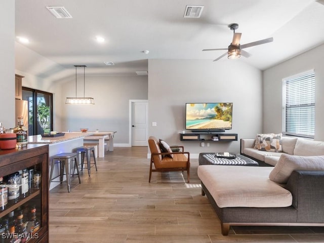 509 SW 8th Ct, Cape Coral, FL 33991 - living area with lofted ceiling, a ceiling fan, light wood-style flooring, beverage cooler, and baseboards