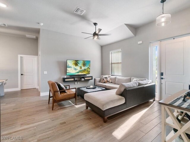 509 SW 8th Ct, Cape Coral, FL 33991 - living area with light wood-style flooring, ceiling fan, lofted ceiling, and baseboards