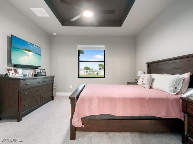 509 SW 8th Ct, Cape Coral, FL 33991 - bedroom featuring light carpet, a ceiling fan, baseboards, and a tray ceiling