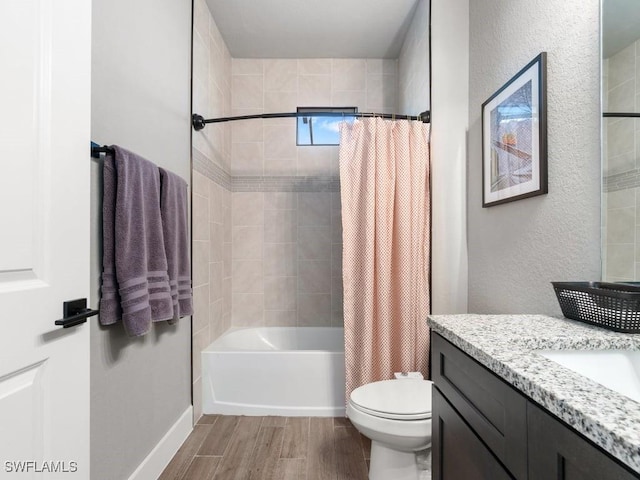 509 SW 8th Ct, Cape Coral, FL 33991 - bathroom featuring wood finished floors, toilet, vanity, shower / bath combination with curtain, and a textured wall