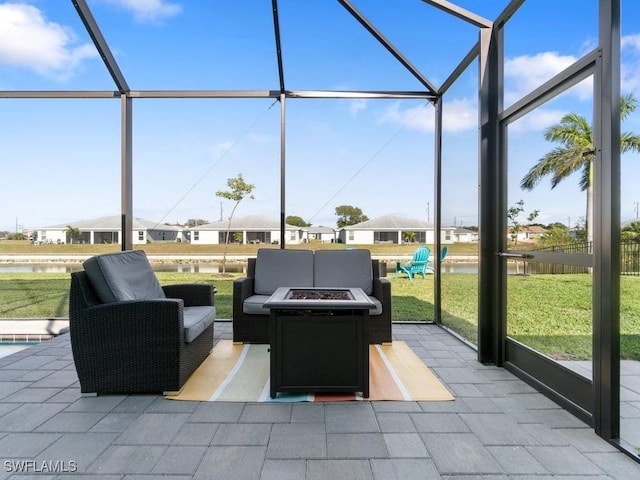509 SW 8th Ct, Cape Coral, FL 33991 - view of patio featuring glass enclosure, a water view, and an outdoor living space with a fire pit