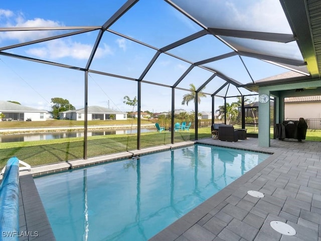 509 SW 8th Ct, Cape Coral, FL 33991 - outdoor pool featuring a water view, a patio area, a lawn, and a lanai