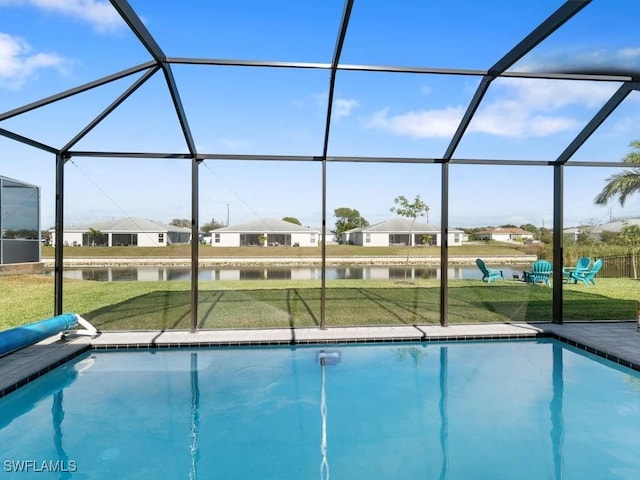 509 SW 8th Ct, Cape Coral, FL 33991 - swimming pool featuring a water view, a lawn, and glass enclosure