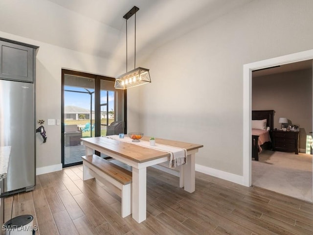 509 SW 8th Ct, Cape Coral, FL 33991 - dining room featuring light wood-style floors, baseboards, and vaulted ceiling