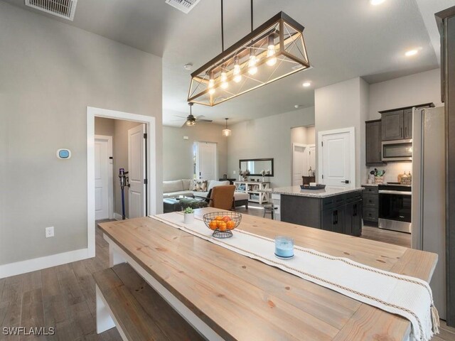 509 SW 8th Ct, Cape Coral, FL 33991 - dining room featuring dark wood-type flooring, ceiling fan, baseboards, and recessed lighting