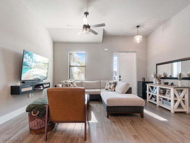 509 SW 8th Ct, Cape Coral, FL 33991 - living room with wood finished floors, a ceiling fan, and baseboards