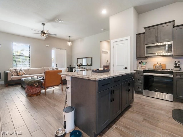 509 SW 8th Ct, Cape Coral, FL 33991 - kitchen featuring stainless steel appliances, light wood-style floors, a ceiling fan, open floor plan, and recessed lighting