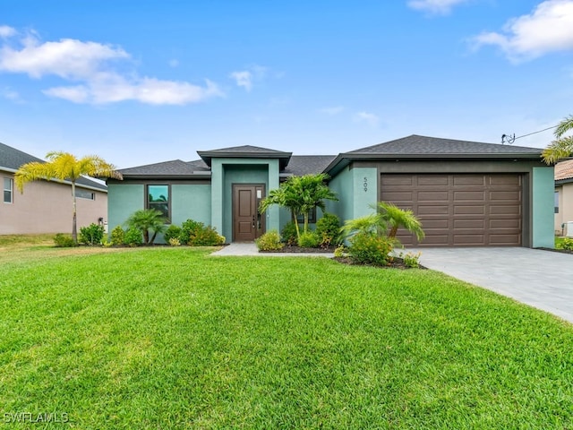 509 SW 8th Ct, Cape Coral, FL 33991 - prairie-style house with stucco siding, a front yard, a garage, and driveway
