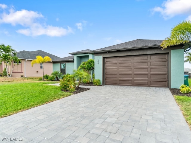 509 SW 8th Ct, Cape Coral, FL 33991 - view of front of house with decorative driveway, a front lawn, stucco siding, and an attached garage