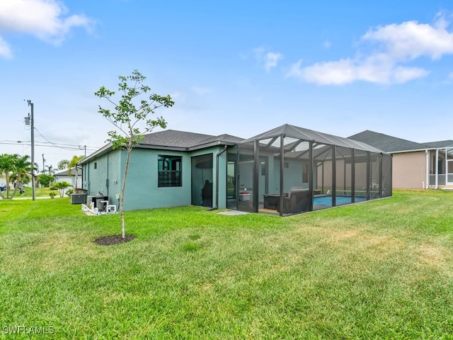 509 SW 8th Ct, Cape Coral, FL 33991 - back of property with a yard, stucco siding, and a lanai