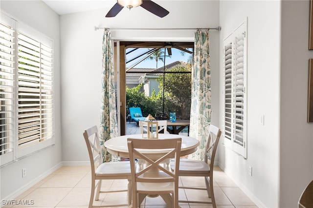 dining room featuring light tile patterned floors, ceiling fan, and baseboards