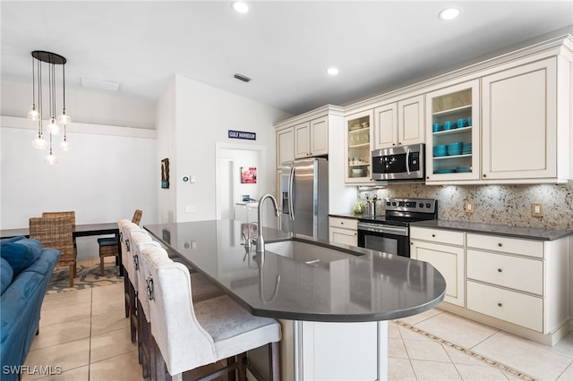 kitchen featuring dark countertops, light tile patterned floors, and stainless steel appliances