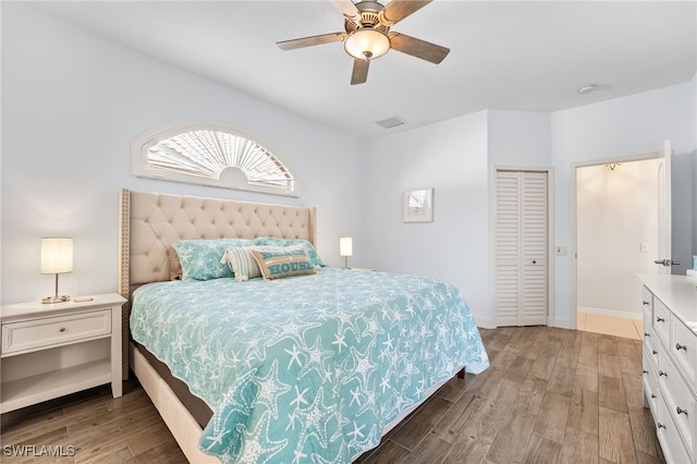 bedroom with visible vents, ceiling fan, baseboards, and wood finished floors