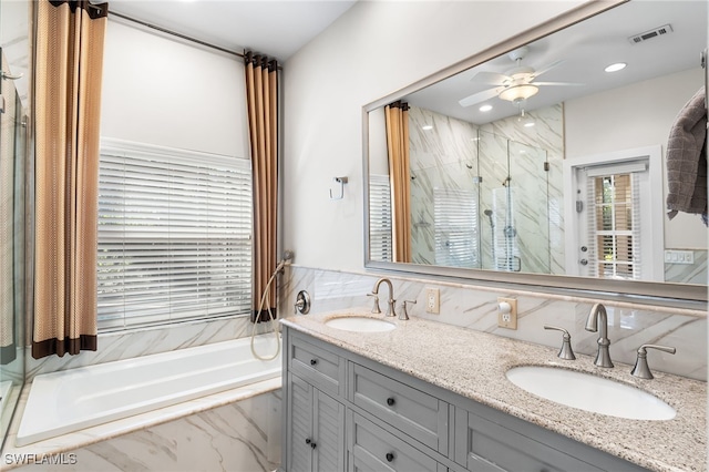 bathroom with a bath, a marble finish shower, a sink, and visible vents