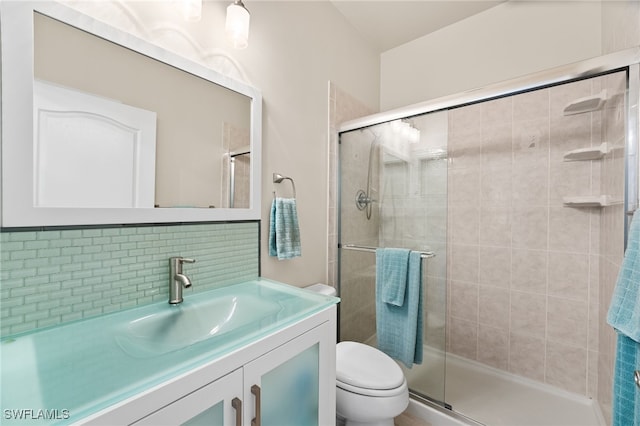 full bath with tasteful backsplash, a shower stall, toilet, and vanity