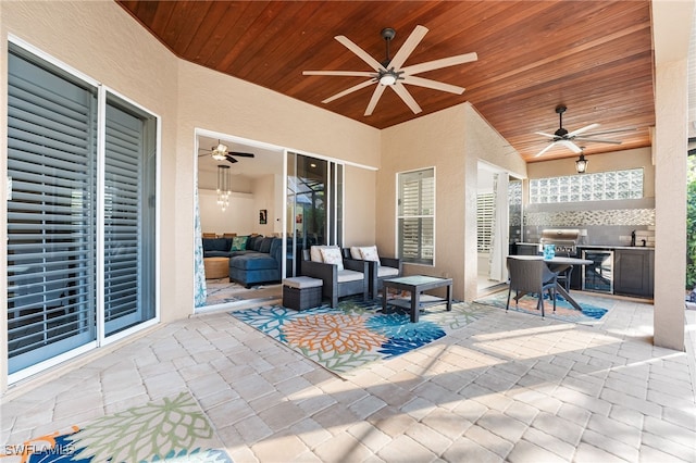 view of patio / terrace with ceiling fan, an outdoor kitchen, beverage cooler, a sink, and an outdoor living space