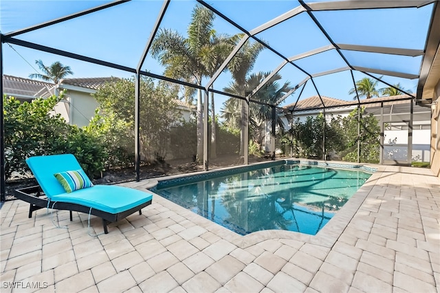 outdoor pool featuring a patio area and a lanai