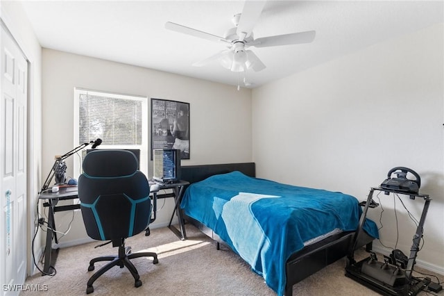 carpeted bedroom with ceiling fan and baseboards