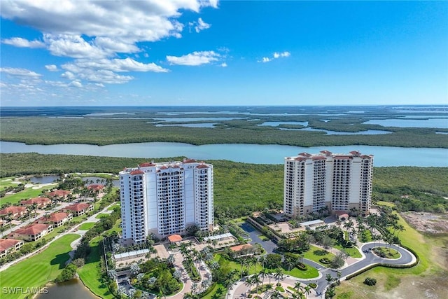 birds eye view of property with a water view and a city view