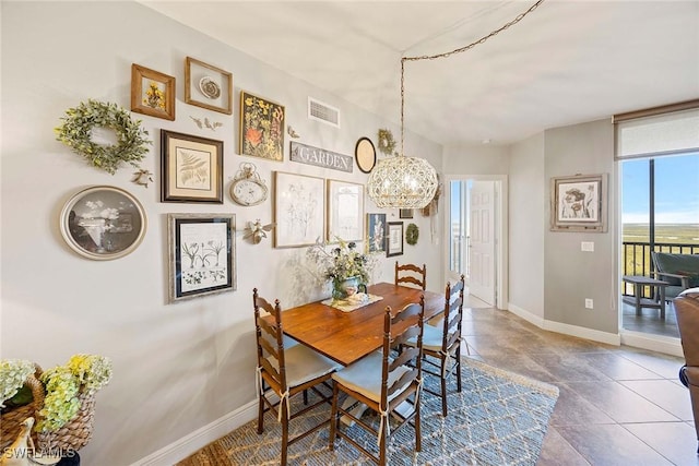 dining room with visible vents, a notable chandelier, and baseboards