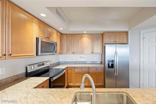 kitchen featuring visible vents, appliances with stainless steel finishes, light stone countertops, a sink, and recessed lighting