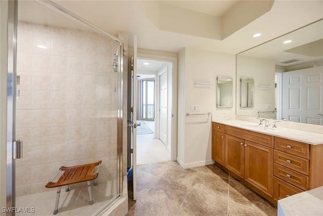 bathroom with recessed lighting, visible vents, a stall shower, vanity, and baseboards