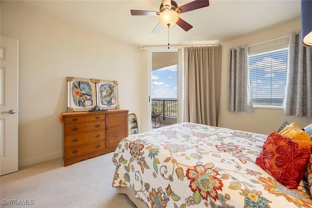 carpeted bedroom with access to exterior, ceiling fan, and baseboards