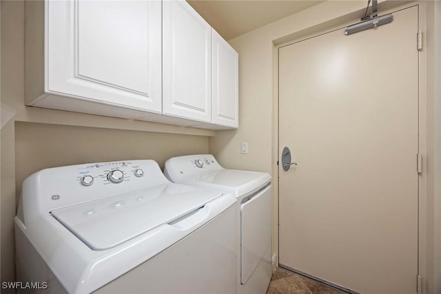 laundry room with cabinet space and washing machine and dryer