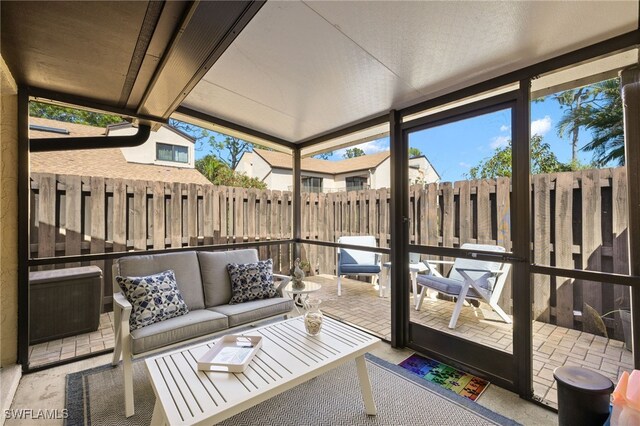 sunroom featuring outdoor lounge area