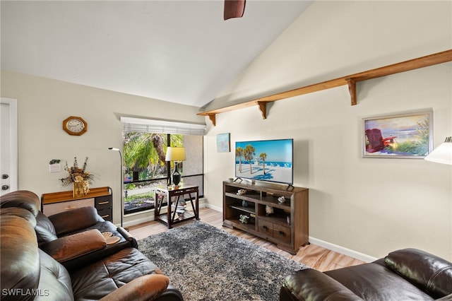 living area featuring ceiling fan, baseboards, wood finished floors, and vaulted ceiling