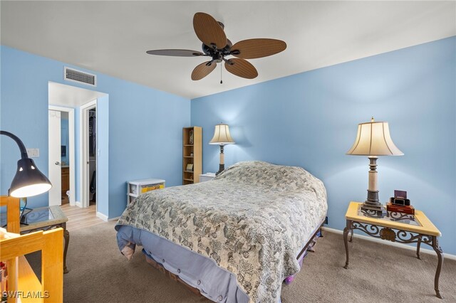 carpeted bedroom featuring visible vents, a ceiling fan, and baseboards